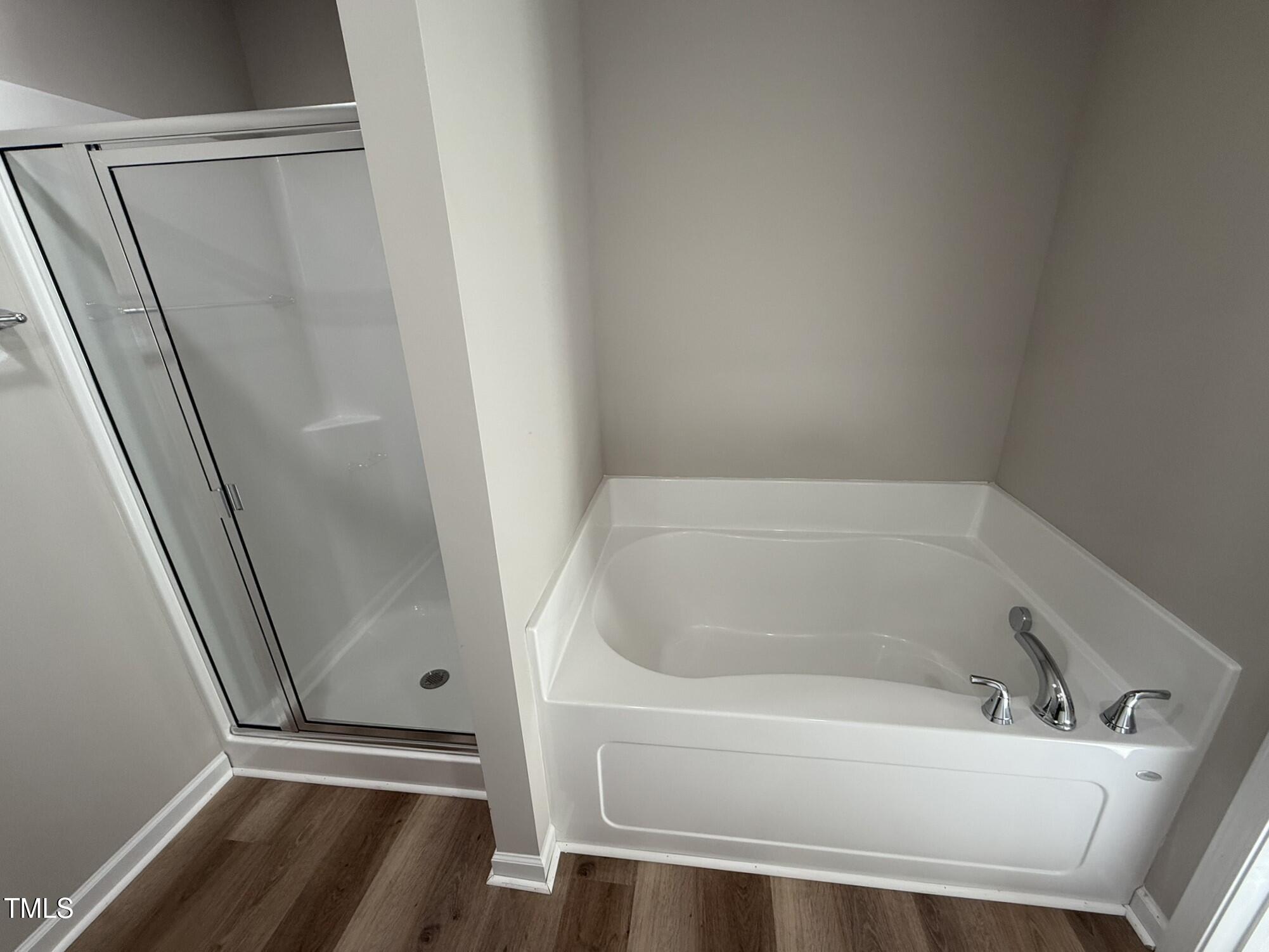 175 Magnolia Run Way Benson, NC 27504 - Photo 17 of 19 a white bath tub sitting next to a sink