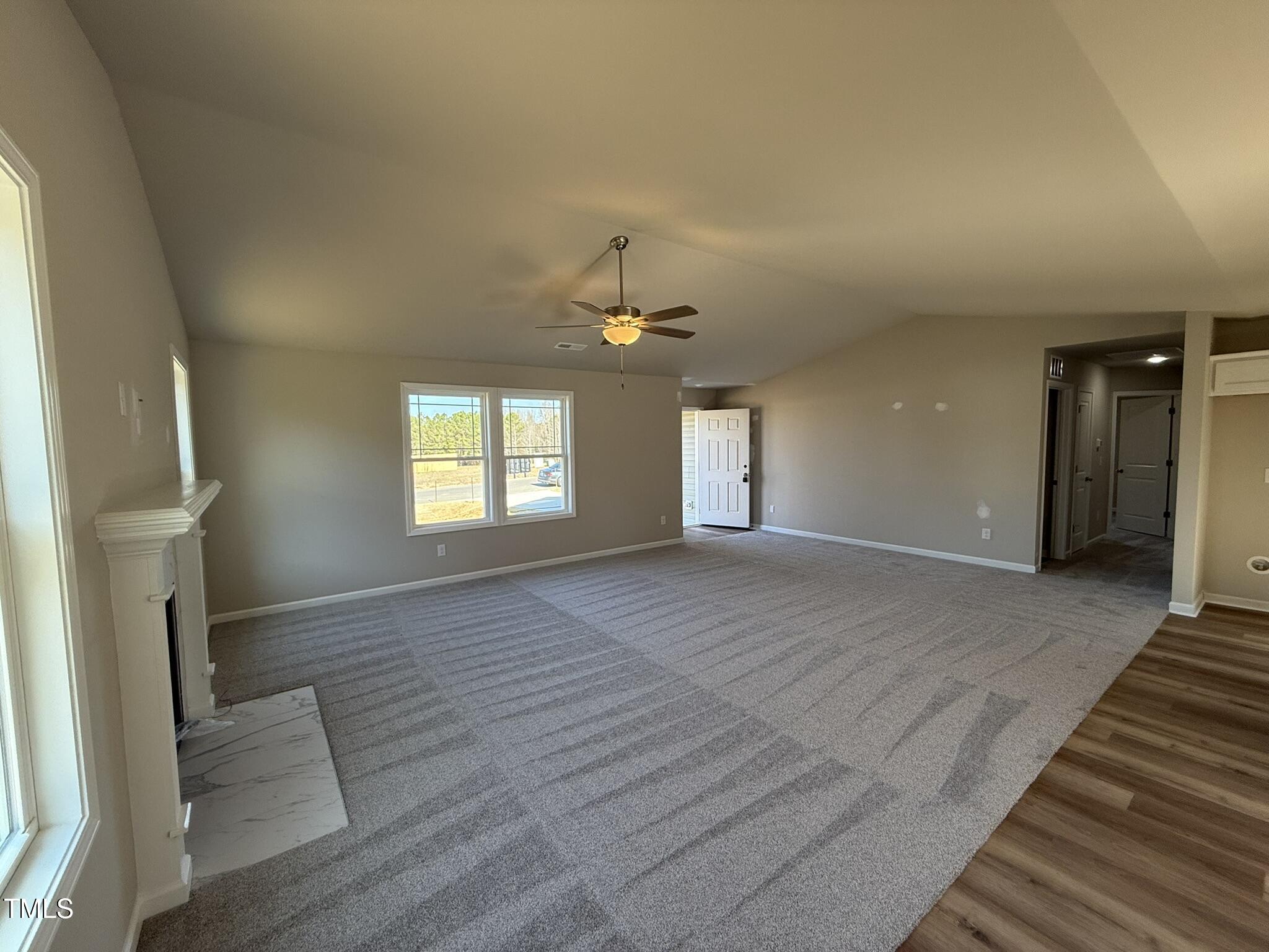 175 Magnolia Run Way Benson, NC 27504 - Photo 4 of 19 wooden floor in an empty room with a window