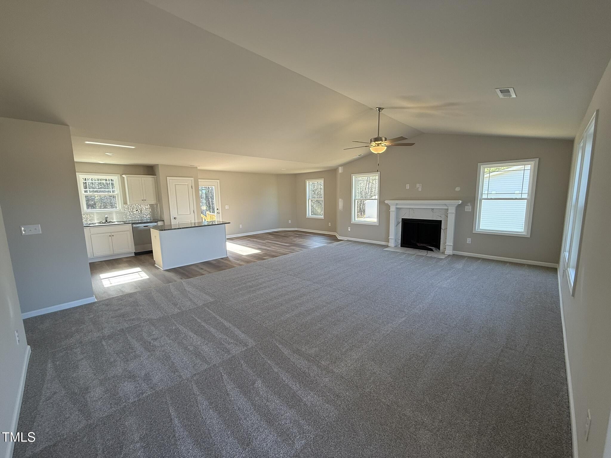 175 Magnolia Run Way Benson, NC 27504 - Photo 7 of 19 a view of empty room with a kitchen and fireplace