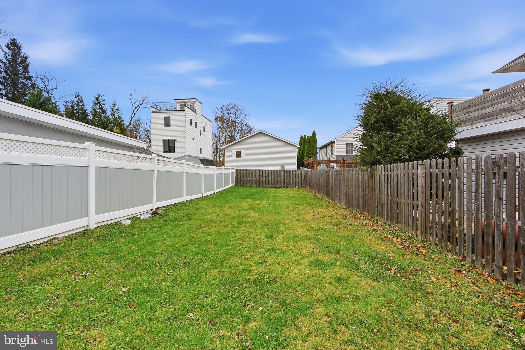 238 Highland Avenue Wayne, PA 19087 - Photo 17 of 17 a view of a house with a small yard and a wooden fence