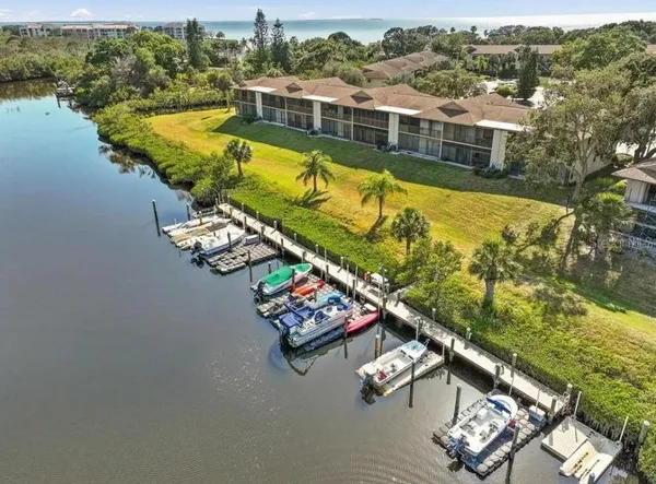 a front view of a house with a garden and mountain
