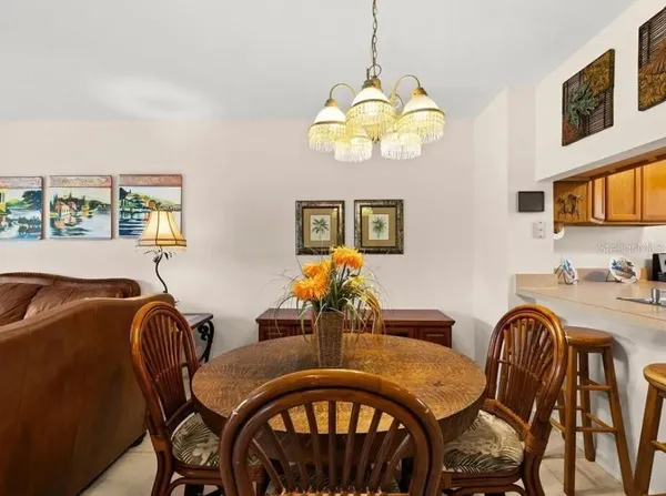a view of a dining room with furniture wooden floor and chandelier