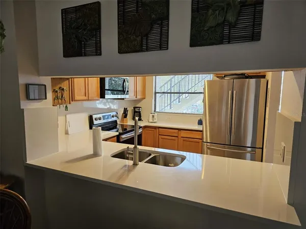 a kitchen with a refrigerator and a sink