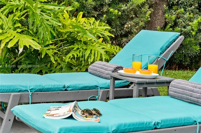a outdoor dining table with chairs and potted plants