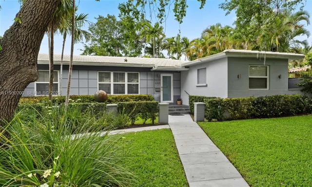 a front view of a house with a yard and table and chairs