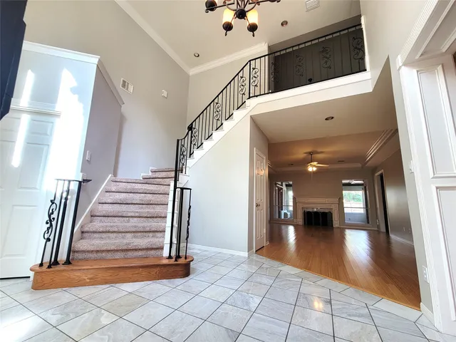 a view of a hallway with entryway wooden floor and livingroom view