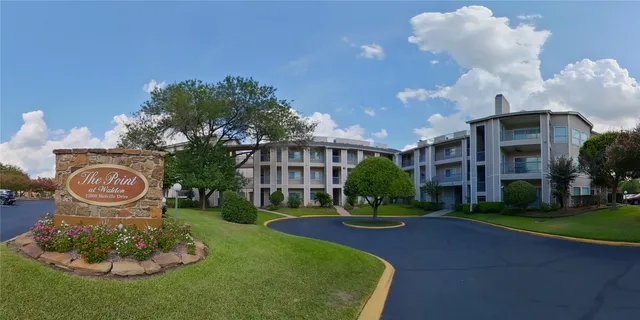 a front view of a house with a yard and fountain