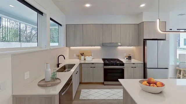 a kitchen with a sink appliances and cabinets