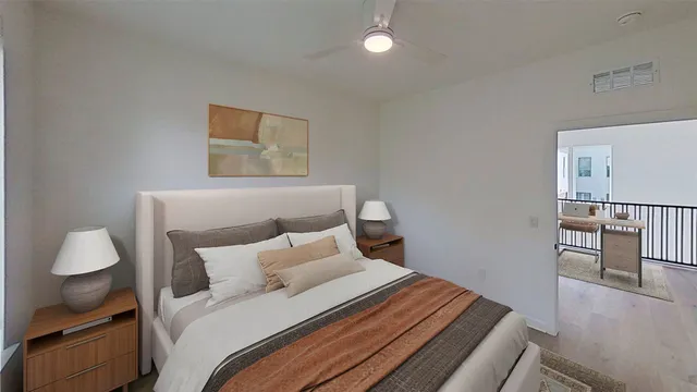 a bedroom with a bed and wooden floor