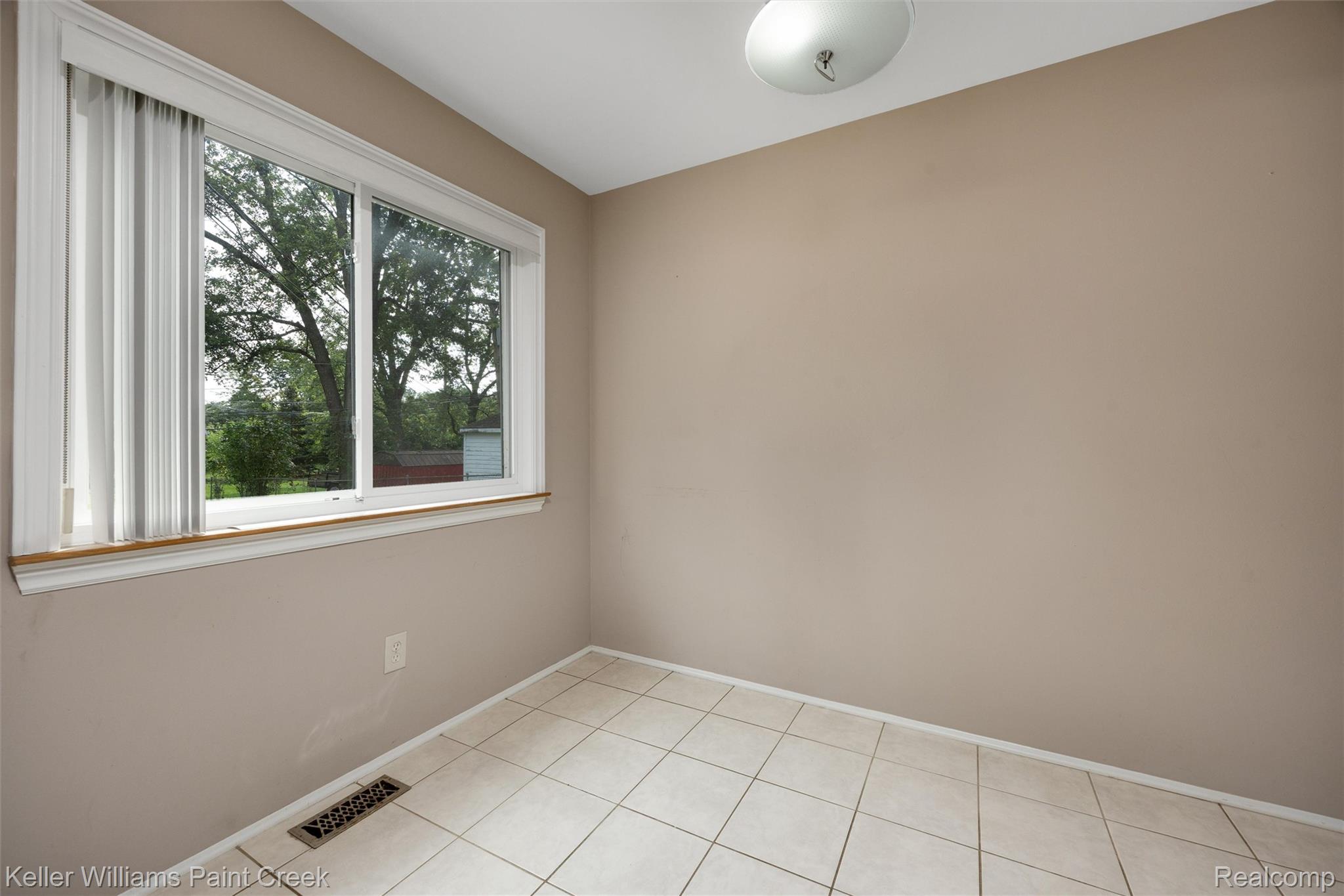 1766 Henry Ruff Road Garden City, MI 48135 - Photo 8 of 36 Neutral wall paint, tiled flooring, white trim, and a flush mount ceiling light