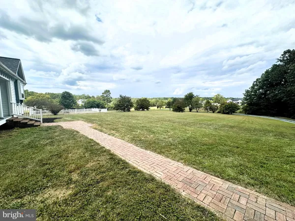 a view of a grassy field with an trees