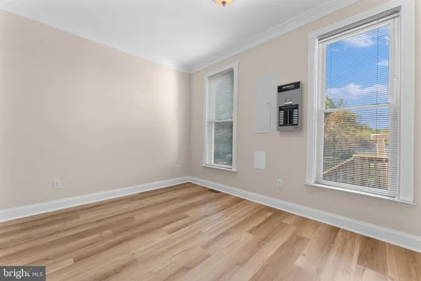 a view of an empty room with wooden floor