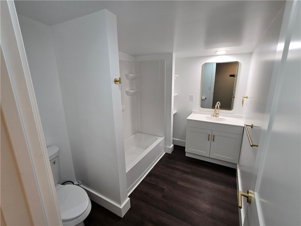 28 Ames Street Seneca, SC 29678 - Photo 14 of 22 Rich dark flooring provides a striking contrast in this updated modern bathroom.