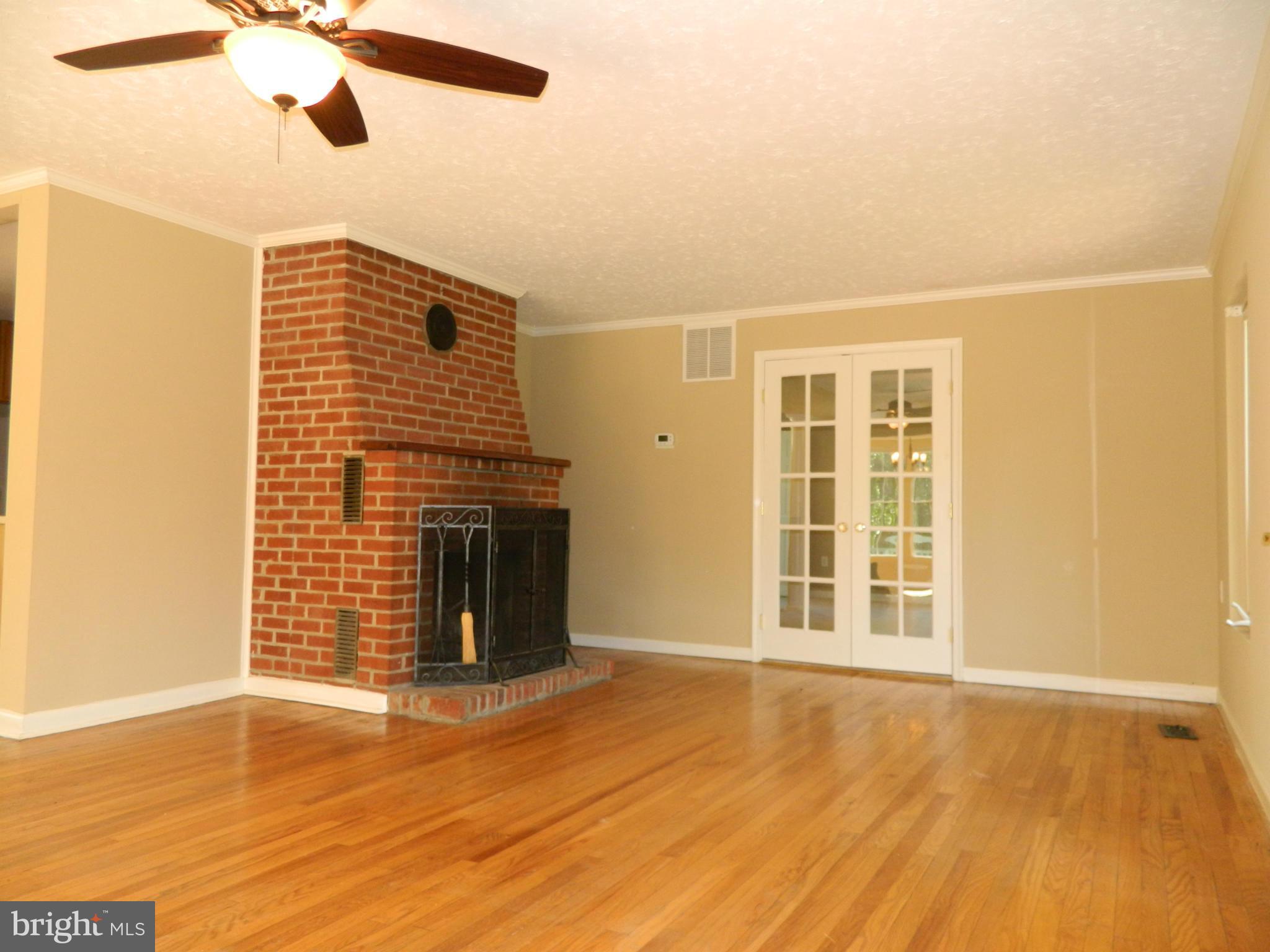 1568 St Margarets Road Annapolis, MD 21409 - Photo 2 of 28 Living Room with Masonry Fireplace and Wood Floors