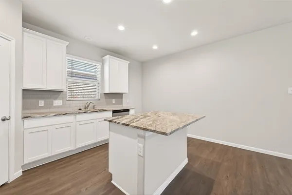 a spacious bathroom with a granite countertop sink mirror and a shower