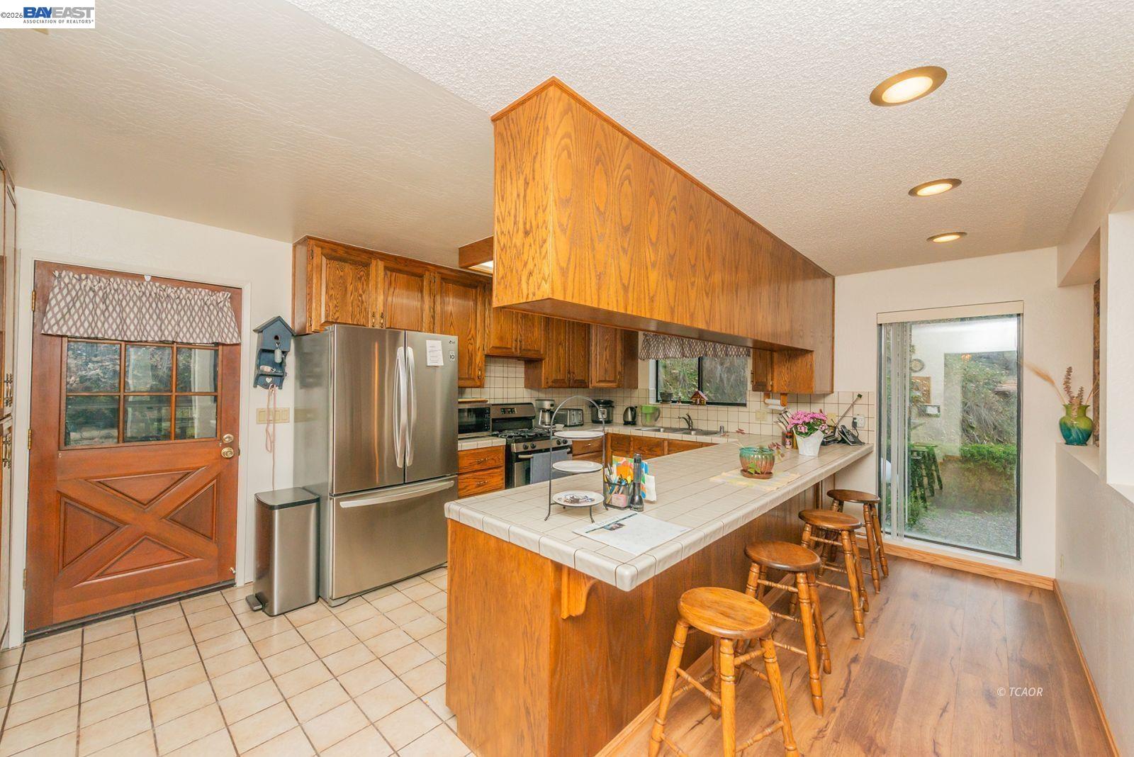 2393 Poker Bar Road Douglas City, CA 96024 - Photo 11 of 52 a kitchen with stainless steel appliances a refrigerator and a stove