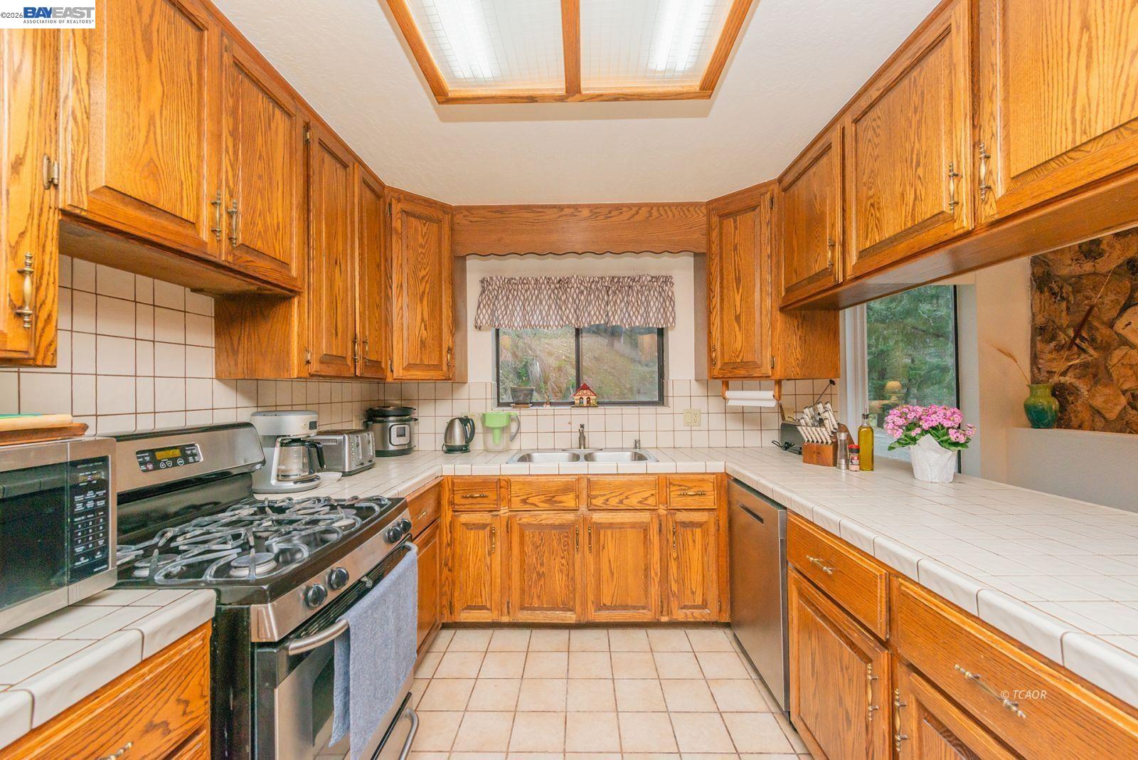 2393 Poker Bar Road Douglas City, CA 96024 - Photo 12 of 52 a kitchen with a sink stove and cabinets