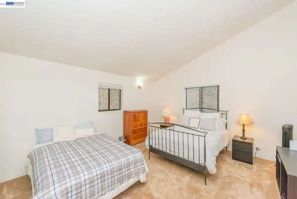a view of a house with a big yard potted plants and large tree