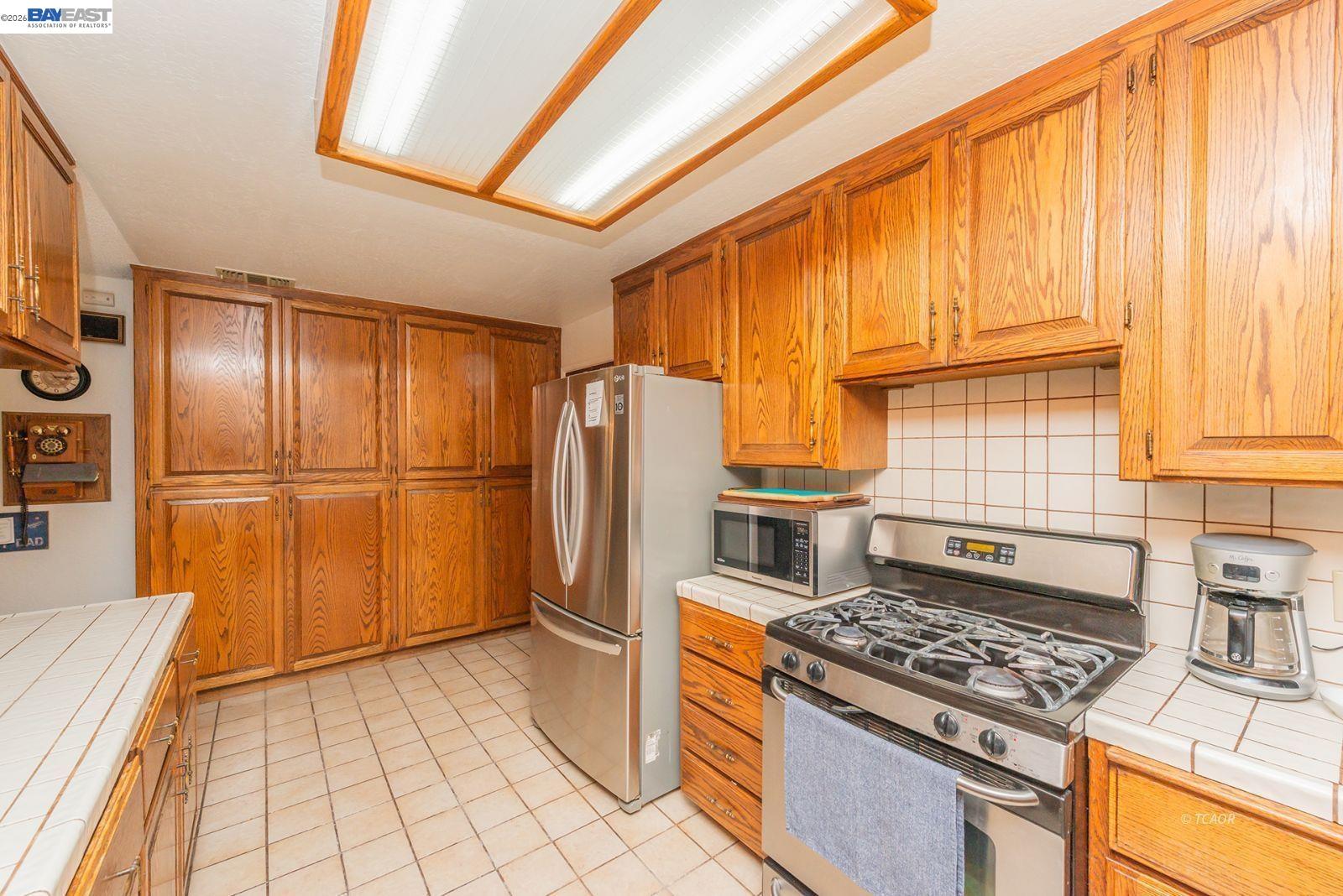 2393 Poker Bar Road Douglas City, CA 96024 - Photo 14 of 52 a kitchen with stainless steel appliances granite countertop a refrigerator a stove and a sink