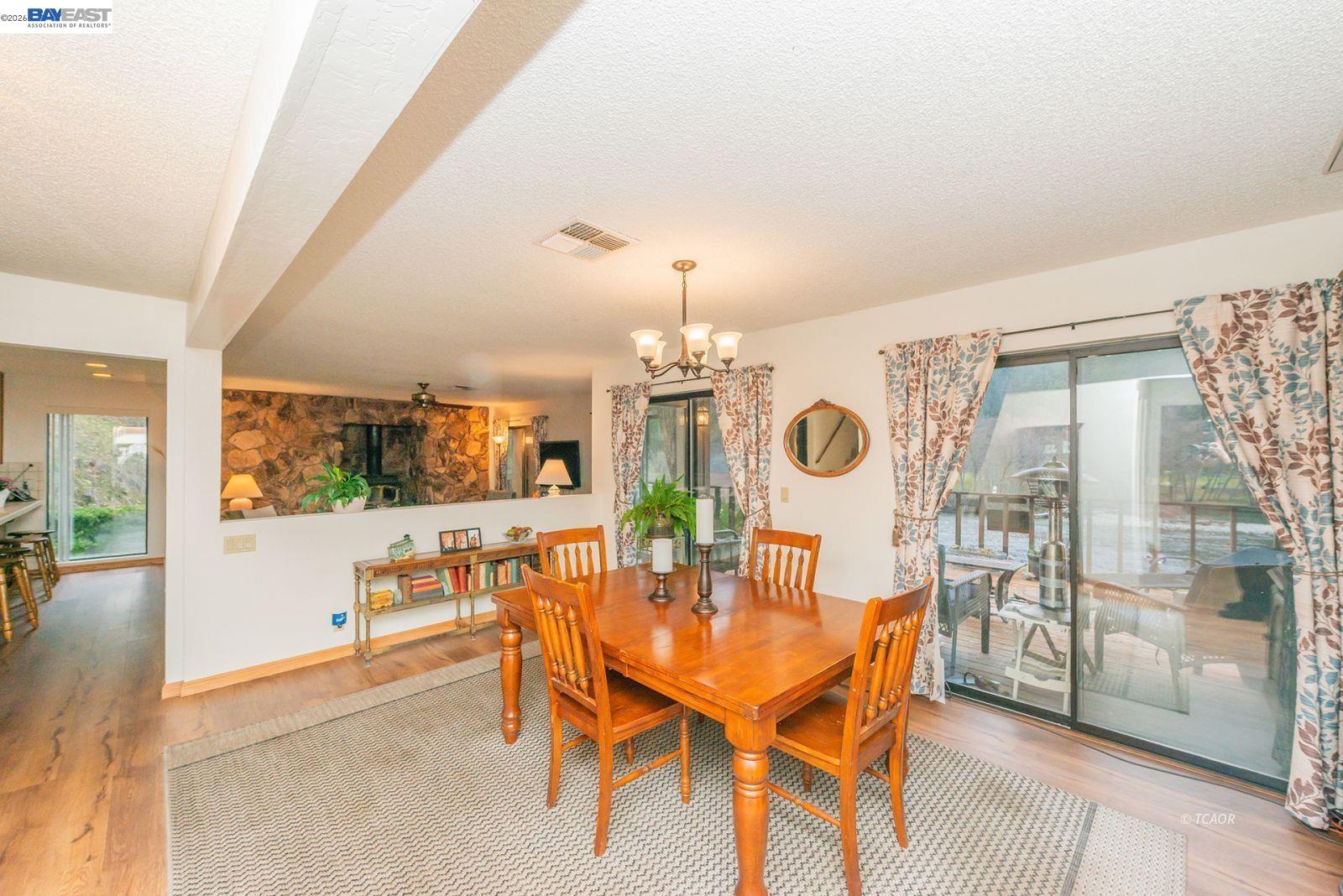 2393 Poker Bar Road Douglas City, CA 96024 - Photo 16 of 52 a view of a dining room with furniture wooden floor and a chandelier
