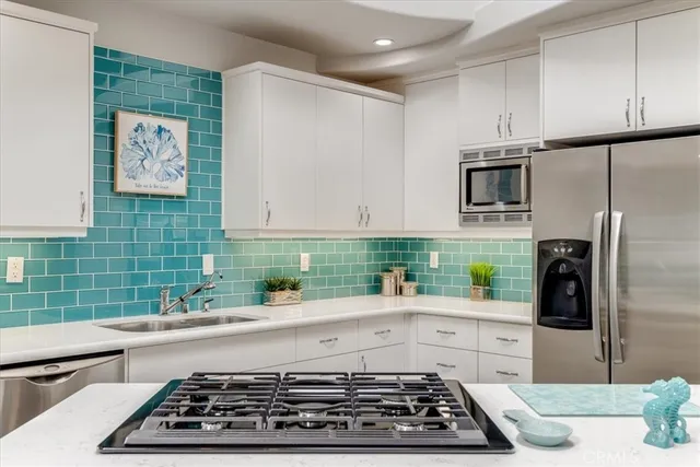a kitchen with sink and stainless steel appliances