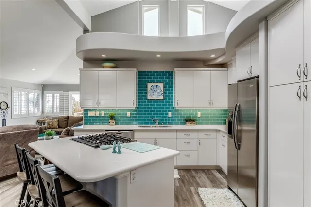 a kitchen with a table chairs refrigerator and cabinets