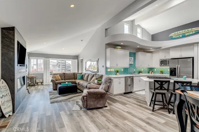 a living room with fireplace furniture and a wooden floor