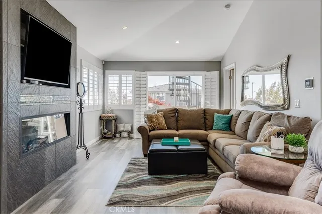 a living room with fireplace furniture and a flat screen tv