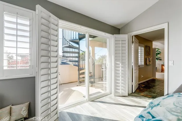 a bedroom with bed and large windows