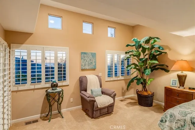 a bedroom with a large bed and a large window