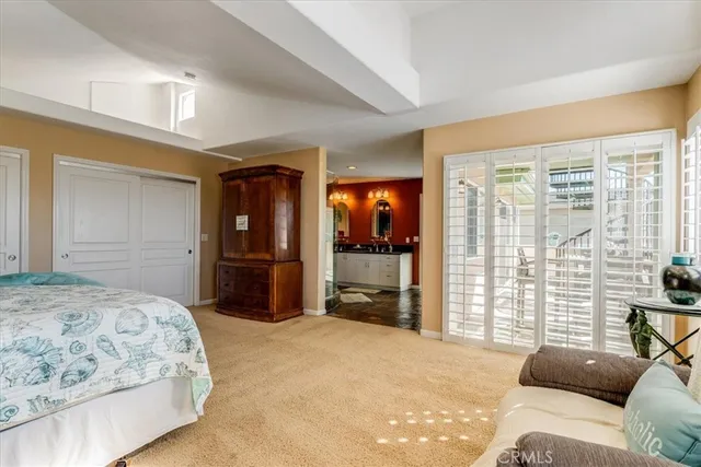 a bedroom with a bed and a potted plant