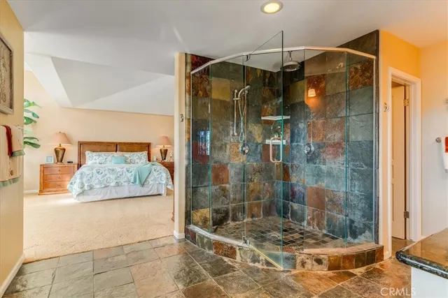 a bathroom with double vanity and a shower