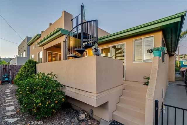 a view of a terrace with furniture and umbrella