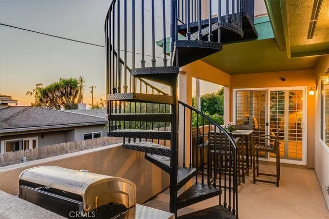 a terrace with outdoor seating and city view