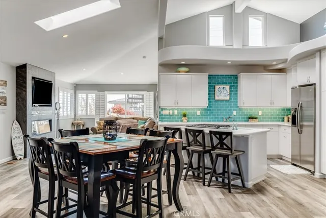 a view of a dining room and livingroom with furniture wooden floor and a rug