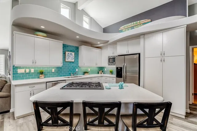 a kitchen with a table chairs and refrigerator