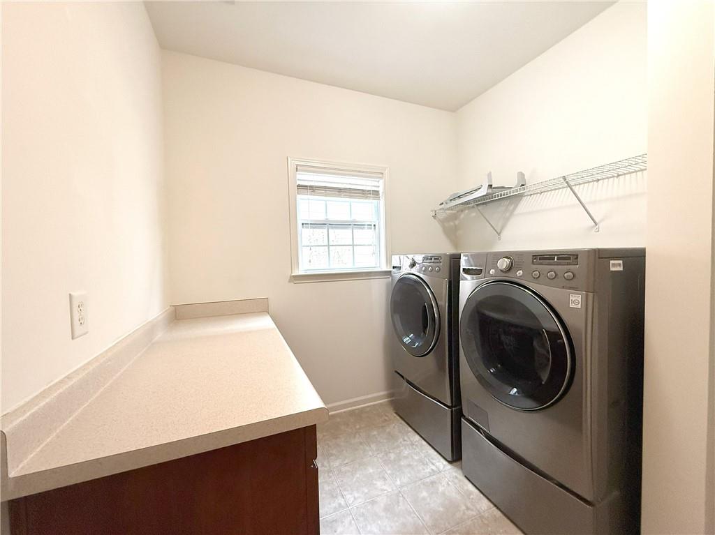 3240 Bentbill Crossing Cumming, GA 30041 - Photo 13 of 30 a view of a kitchen with washer and dryer