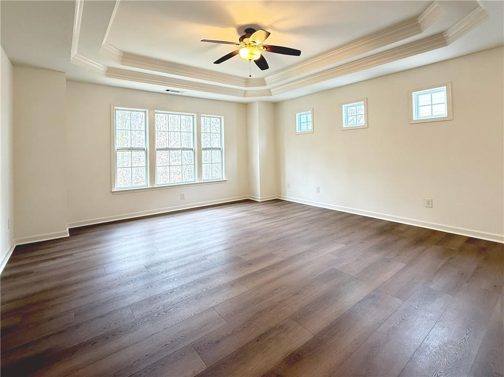 3240 Bentbill Crossing Cumming, GA 30041 - Photo 16 of 30 a view of an empty room with wooden floor and a window