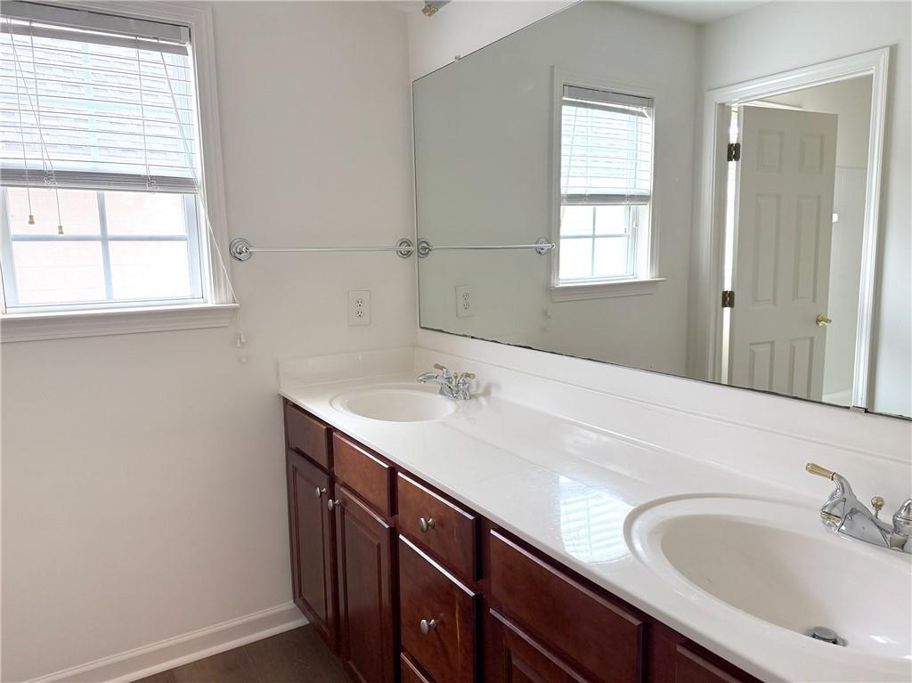 3240 Bentbill Crossing Cumming, GA 30041 - Photo 25 of 30 a bathroom with a sink and a window