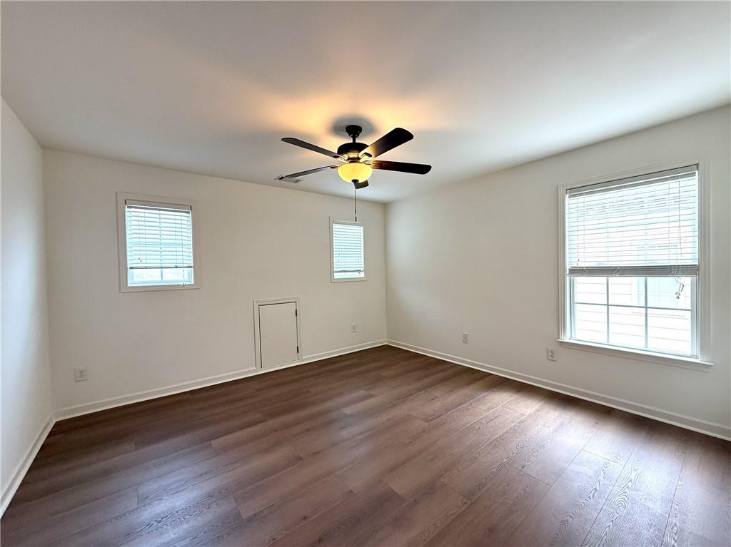 3240 Bentbill Crossing Cumming, GA 30041 - Photo 28 of 30 an empty room with wooden floor and windows