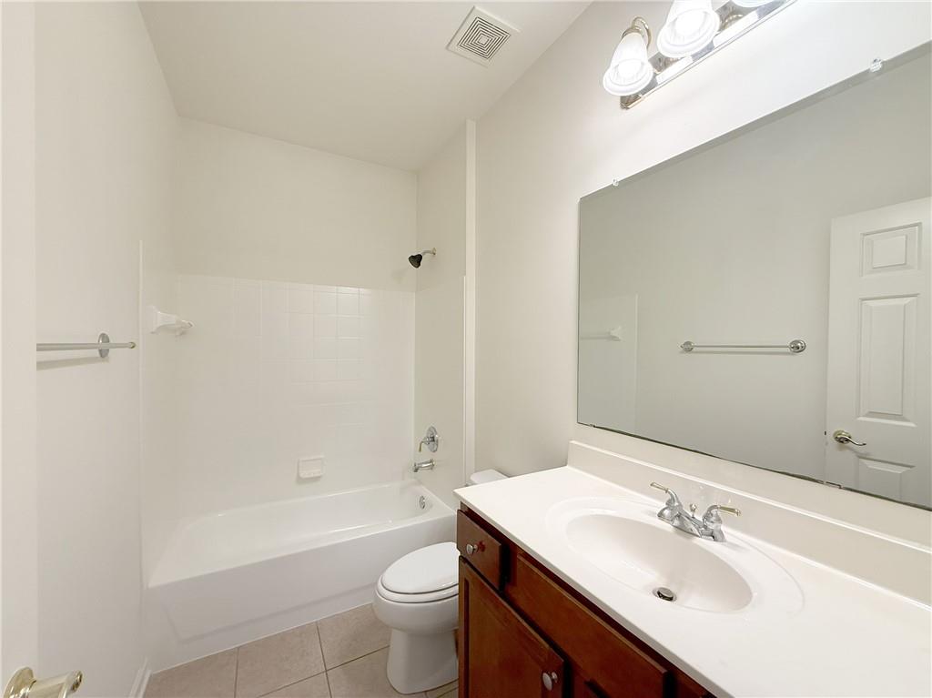 3240 Bentbill Crossing Cumming, GA 30041 - Photo 7 of 30 a bathroom with a sink mirror toilet and bathtub