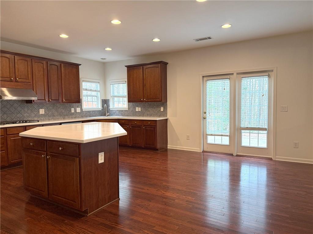 3240 Bentbill Crossing Cumming, GA 30041 - Photo 10 of 30 a kitchen with wooden floors and sink