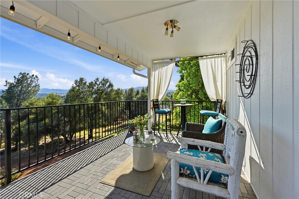 17432 Greenridge Road Hidden Valley Lake, CA 95467 - Photo 47 of 72 a balcony with furniture and a potted plant
