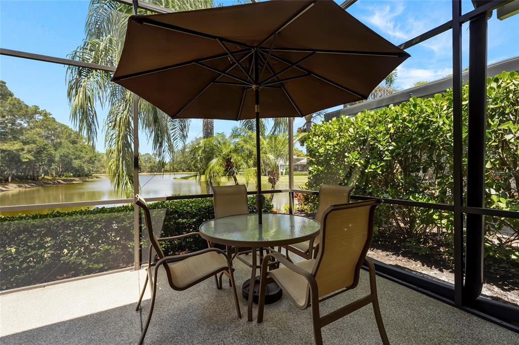 7822 Troon Court Lakewood Ranch, FL 34202 - Photo 15 of 83 a patio with a yard table and chairs