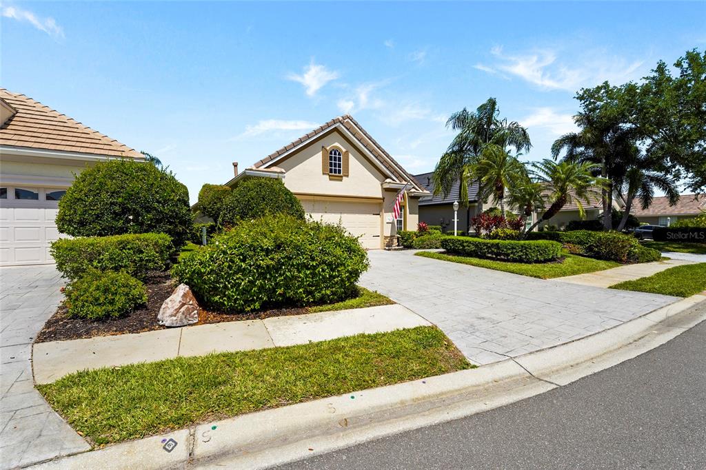 7822 Troon Court Lakewood Ranch, FL 34202 - Photo 19 of 83 a front view of a house with a yard and garage