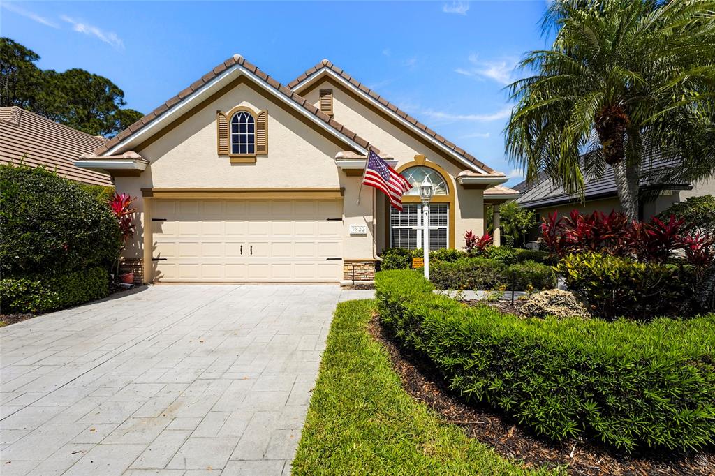 7822 Troon Court Lakewood Ranch, FL 34202 - Photo 2 of 83 a front view of a house with a yard
