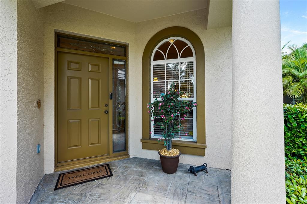 7822 Troon Court Lakewood Ranch, FL 34202 - Photo 22 of 83 a front view of a house with garden