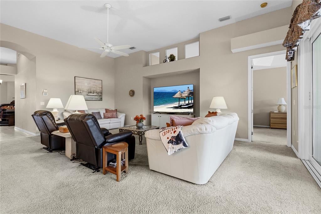 7822 Troon Court Lakewood Ranch, FL 34202 - Photo 27 of 83 a living room with furniture and a flat screen tv