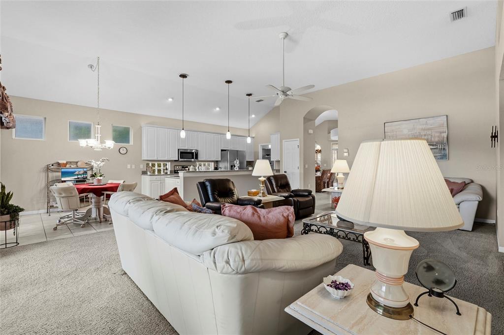 7822 Troon Court Lakewood Ranch, FL 34202 - Photo 28 of 83 a living room with furniture and a chandelier