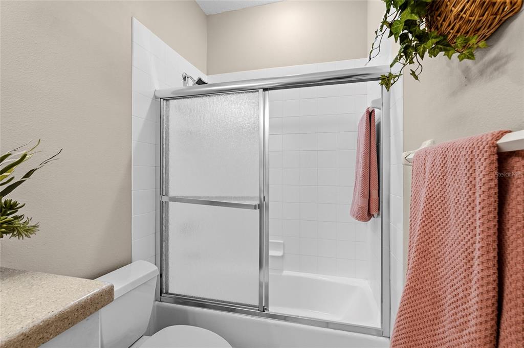 7822 Troon Court Lakewood Ranch, FL 34202 - Photo 40 of 83 a bathroom with a shower and a toilet